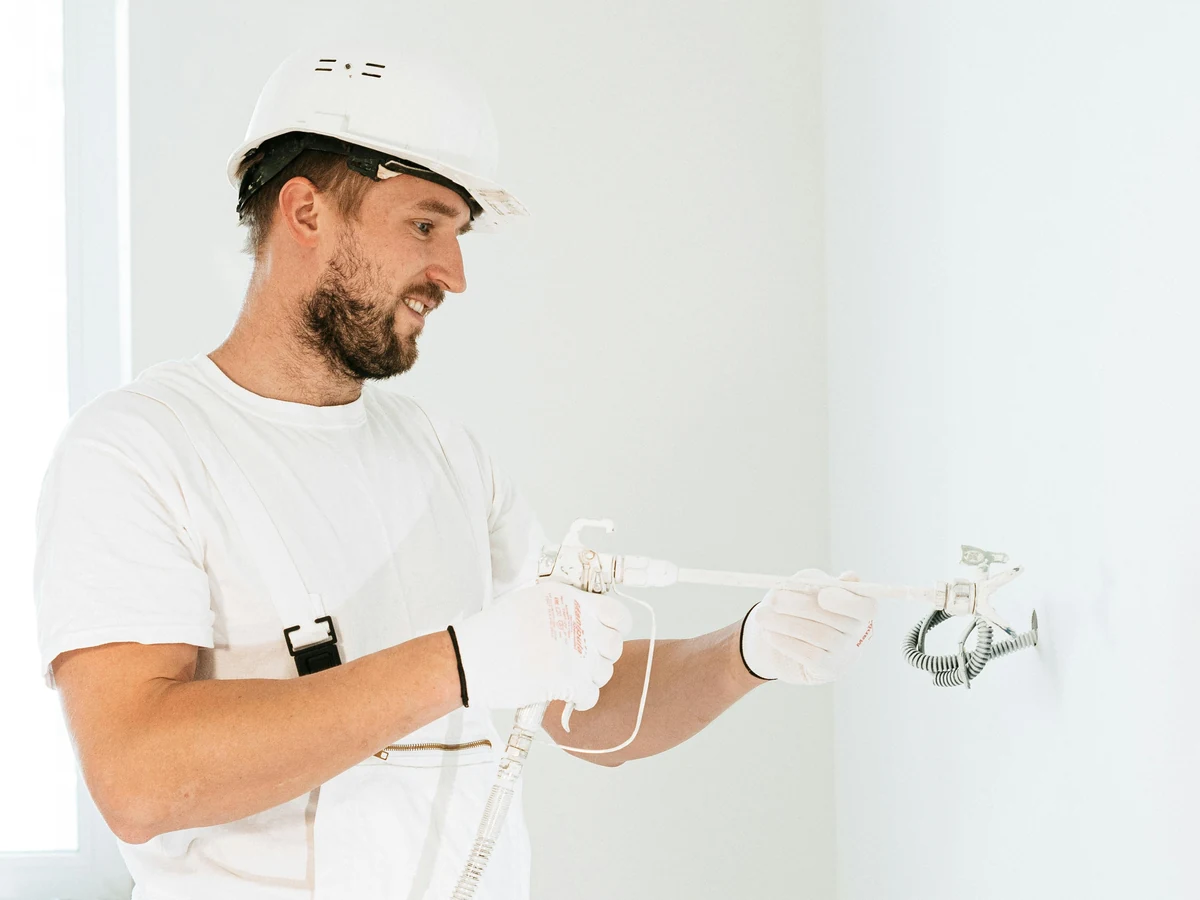painting-decorating-worker-hardhat-examining-reading-decorators Reading Decorators painter examining commercial premises before work