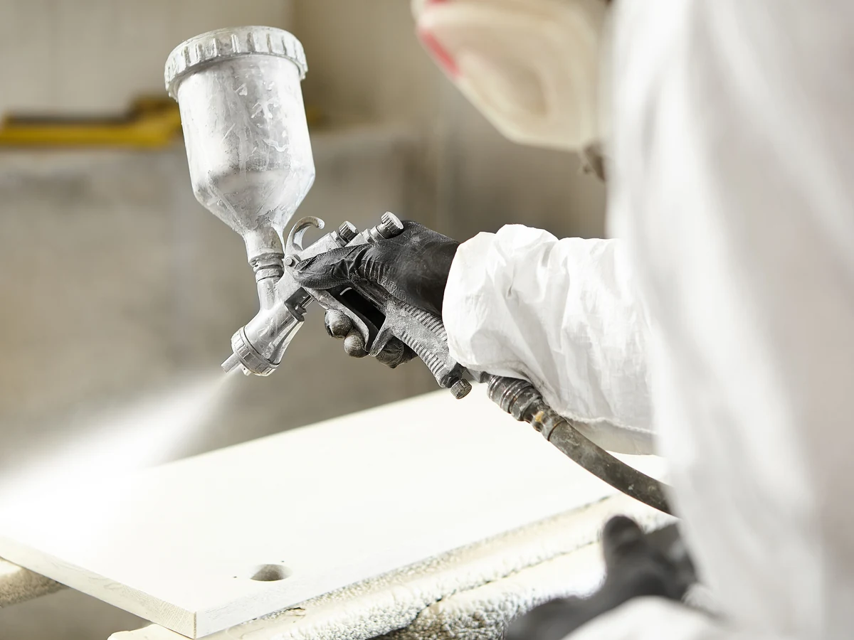 Painting and decorating in Streatley by Reading Decorators, professional decorator in white suit